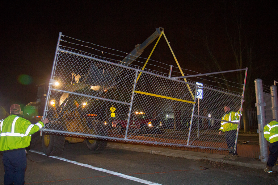 Monmouth County Public Works and Engineering personnel removes the temporary fencing on County Route 537 in preparation of its opening on Jan. 17, 2017 .